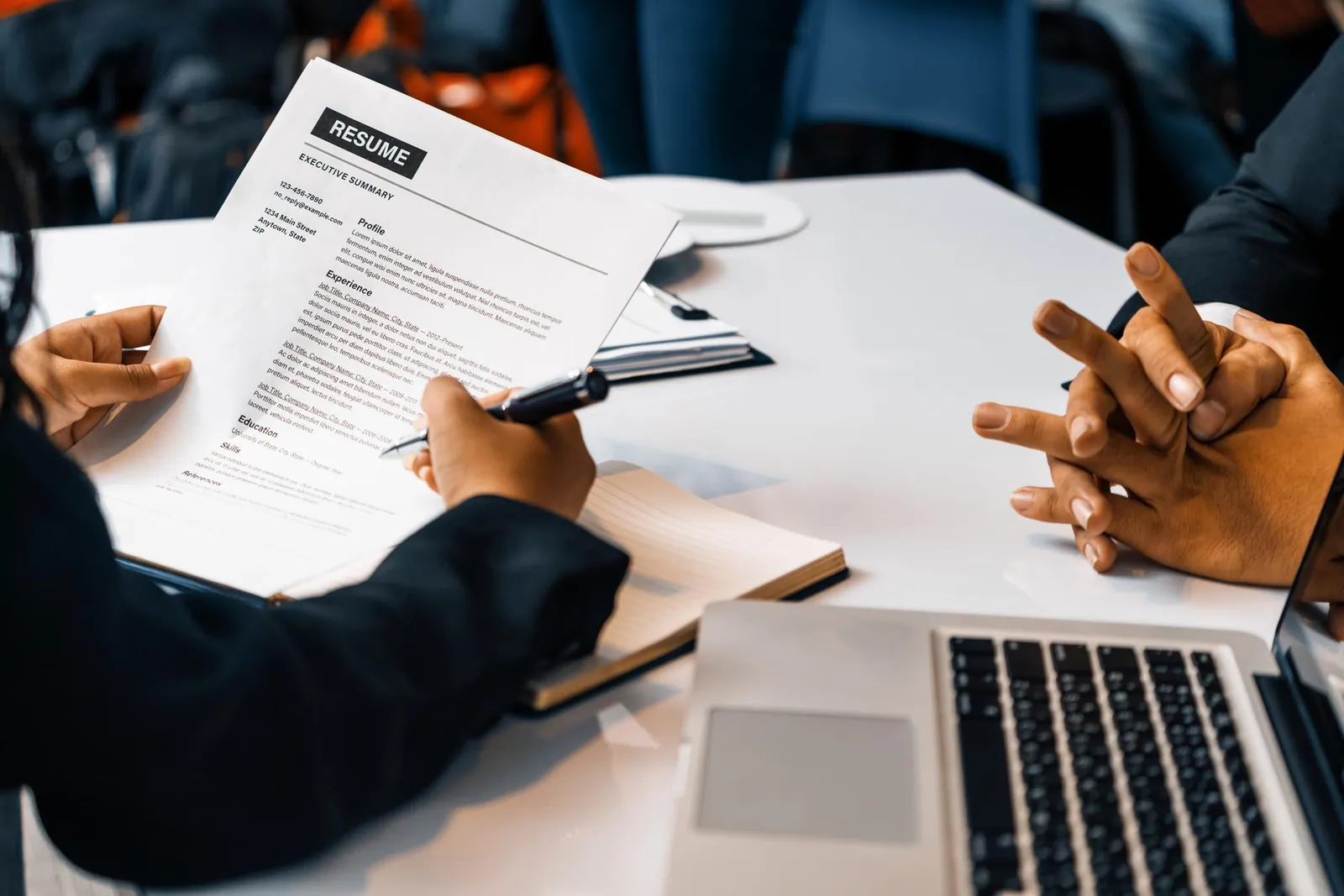 Interviewer reviewing a candidate's resume across a desk