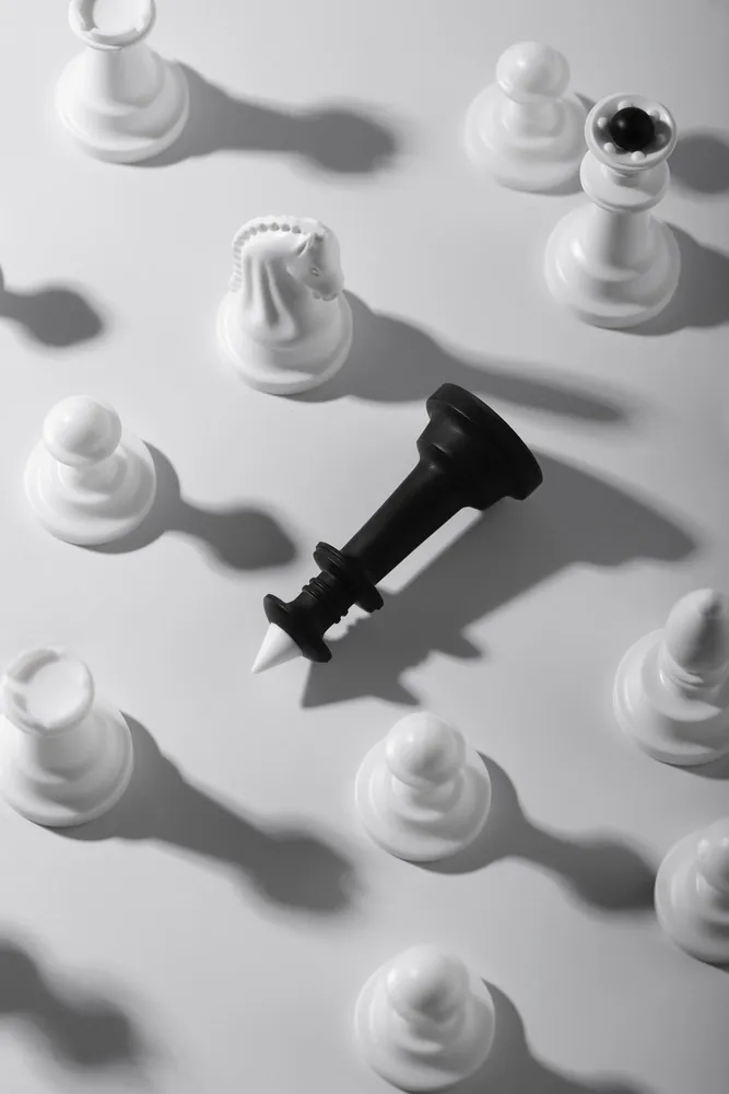 Chess pieces with a fallen king