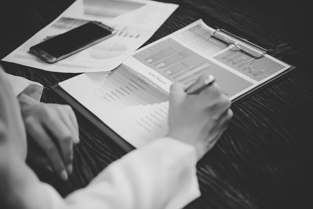 Reviewing portfolio performance charts on paper
