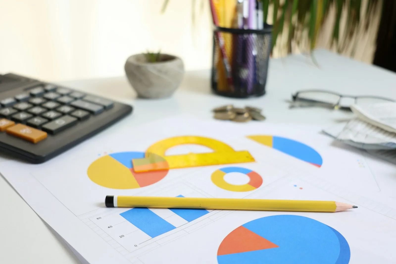 Desk with printed charts and a calculator during a business review