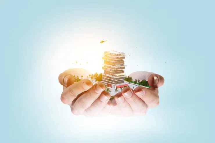 Hands holding a model of a growing development