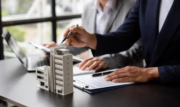 Property manager reviewing documents with a building model